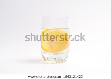 A picture of lemon water on white background. It helps to support weight loss.