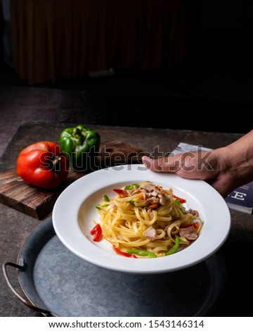 A plate of Spicy Fettuccine Aglio e Olio in Darkmood, picture was taken in October 2019 in Bandung Indonesia 
