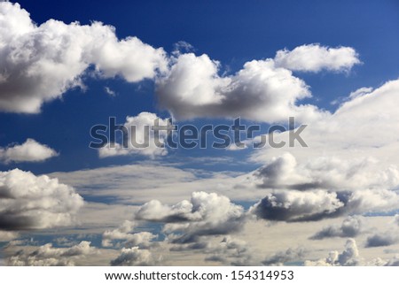 White clouds against a blue sky on a sunny day.