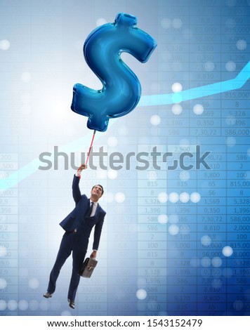The businessman flying on dollar sign inflatable balloon