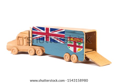 Close-up of a wooden toy truck with a painted national flag Fiji. The concept of export-import,transportation, national delivery of goods 