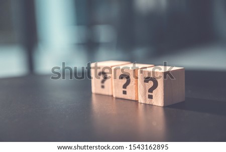 Questions Mark word in wooden cube block on table background. FAQ  Answer, Q&A.