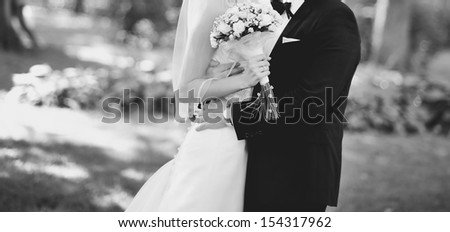 classic wedding picture, Married Couple embracing outside, black and white