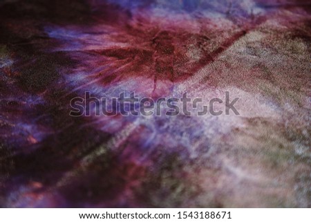 Abstract pattern on shiny violet fabric with glitter, background