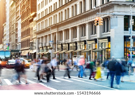 New York City street scene with crowds of diverse people in motion through a busy intersection on 5th Avenue in Midtown Manhattan NYC Royalty-Free Stock Photo #1543196666