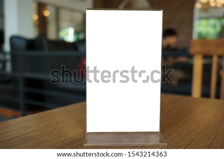 Menu frame standing on wood table in Bar restaurant cafe. space for text marketing promotion.