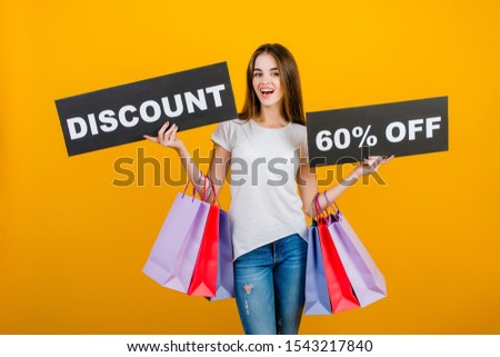 beautiful brunette woman with colorful shopping bags and copyspace text discount 60% sign isolated over yellow