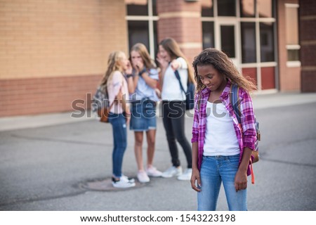 One student being bullied and talked behind back while other students gossiping. Social and school bully concept. Royalty-Free Stock Photo #1543223198