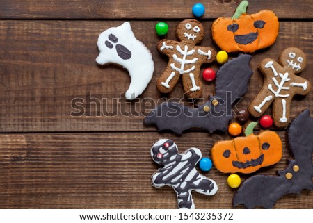 Halloween wood background with colorful cookies, flat lay