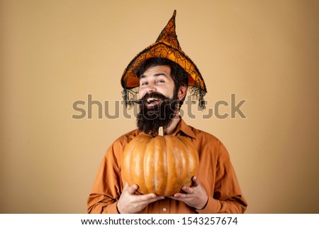 Portrait of Handsome man with pumpkin over isolated background. Handsome man in Halloween hat holding pumpkin - portrait close up. Happy Halloween Stickers