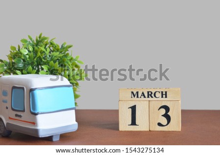March cover design with number cube and car, Date 13.