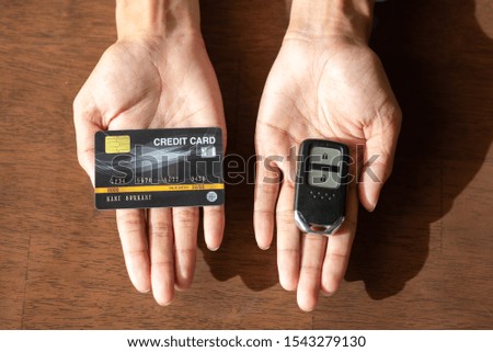 Credit cards and Car keys in hand
