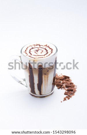 Hot chocolate and warming cocoa with marshmallow and waffle tubes, chocolate and marshmallows in a beautiful mug with a traditional ornament.Pictures for the menu of bar and restaurant.Autumn drinks