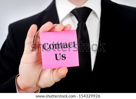 Businessman showing postcard with contact us