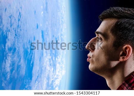Man kissing Earth planet . Mixed media