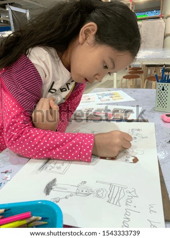 Asian kid girl drawing picture. children leisure activity.