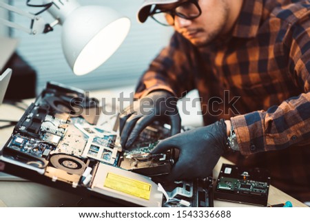 Technician reparing a broken computer. Computer service and repair concept.