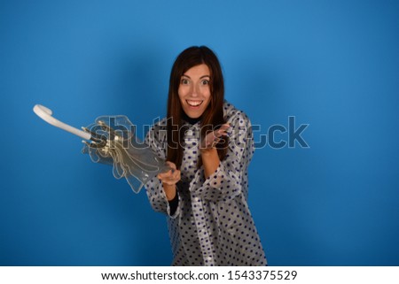 smiling woman with umbrella over blue background