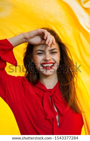 young woman with red lipstick looks at the camera model