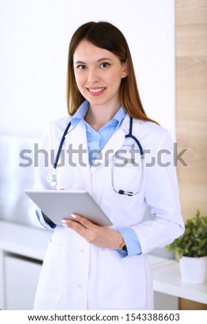 Asian doctor woman happy and cheerful while using laptop computer in hospital or clinic background. Medicine and health care concept