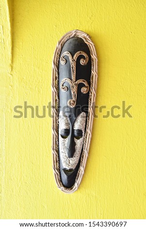 tribal wooden mask on a yellow background, photo as a background , Beautiful digital image