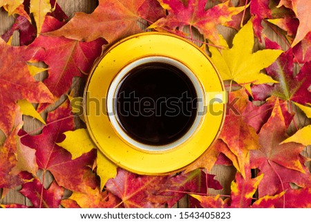 cup with black coffee on a wooden table with autumn fallen yellow, orange and red leaves Flat lay Top view Mock up Hello september, october, november, sesonal concept
