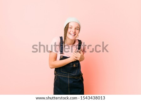 Hispter teenager woman laughing keeping hands on heart, concept of happiness.