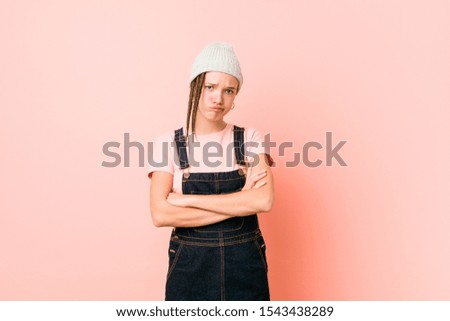 Hispter teenager woman unhappy looking in camera with sarcastic expression.