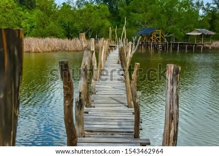 A wooden bridge at a lake in Thailand.