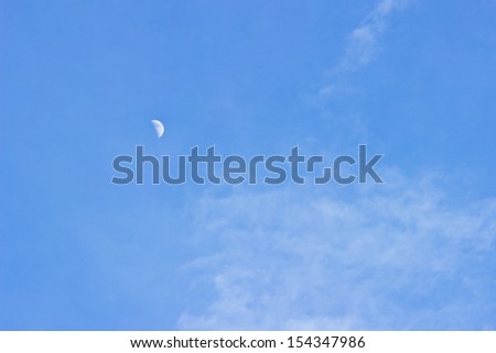 Moon on blue sky background.