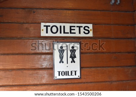 Funny sign for toilets with crossed legs for women and men