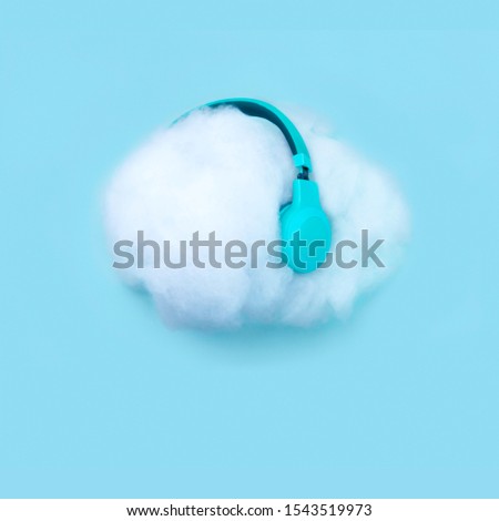 Cloud in the headphones listening to music and audio books. Cloud service, Wireless communication network, IoT Internet of Things and ICT concept. Minimal design. Can be used in weather projects.