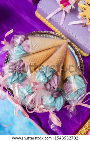 Blue and purple ice cream style cupcakes with cone - IMAGE