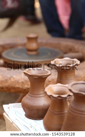 Making of Earthen Pot with the help of the hand wheel.