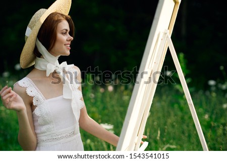 young woman outdoors with a beautiful hat model