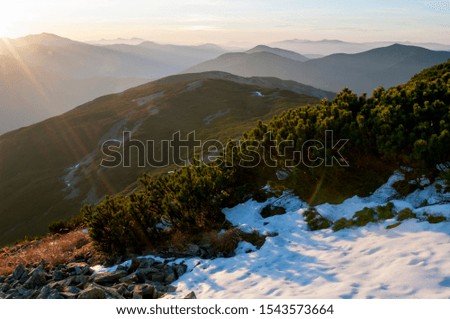 the first snow in the sunny mountains with a beautiful panorama