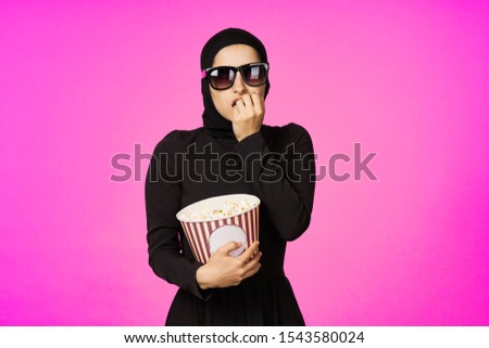young woman looking at the camera isolated background with popcorn