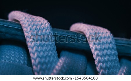 Close up beautiful white shoeloces with color light background texture. Macro photography view.