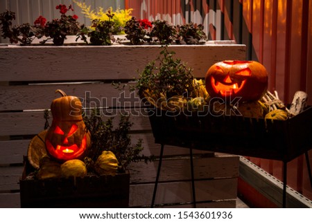 Halloween pumpkins with carved demonic faces and candles inside. festive  beautiful pumpkins. Night photo.