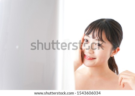 Young woman making up at home