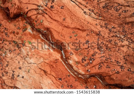 Aerial view of dried out red clay dirt with cracks in clay quarry.