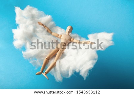 Toy man relax on cloud bed. Business freedom, keep calm.