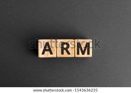 ARM - acronym from wooden blocks with letters, Advanced RISC Machine ARM concept chip architectures microprocessor technology,  top view on grey background