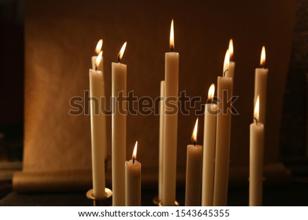 Burning candles indoor.  Candle lights in dark background.
