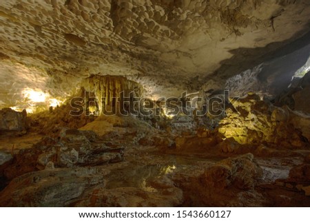 An inside view of the Surprise Cave (Sung Sot) in Vietnam. Tourists can get free entry to this cave which has a very small opening. The cave has a breathtaking view once you go inside. Royalty-Free Stock Photo #1543660127
