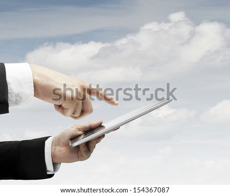 hand holding and pushing touch pad on sky backgrounds
