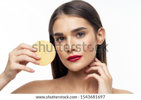 beautiful woman with bright makeup round sponge clean skin