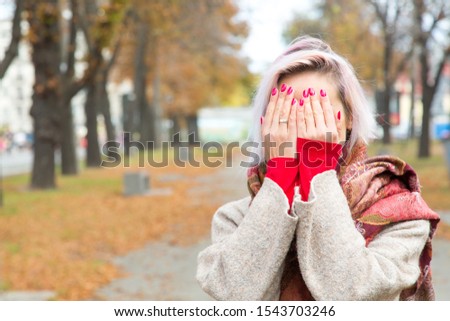 The young woman covered her face with her hands.