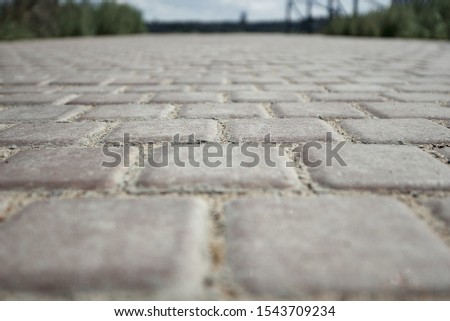 Paving tiles background. Paving slabs close-up. Foreground and background in blur.