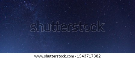 Panorama blue night sky milky way and star on dark background.Universe filled with stars, nebula and galaxy with noise and grain.Photo by long exposure and select white balance.selection focus.amazing Royalty-Free Stock Photo #1543717382